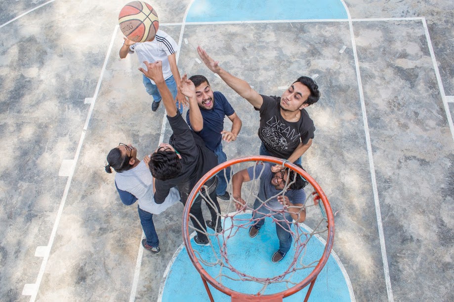 boys playing basketball in the court